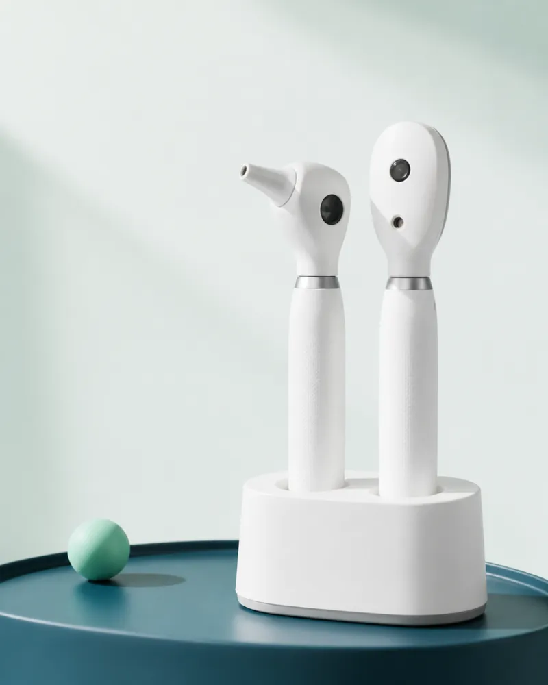 Otoscope and ophthalmoscope handles in a white charging cradle